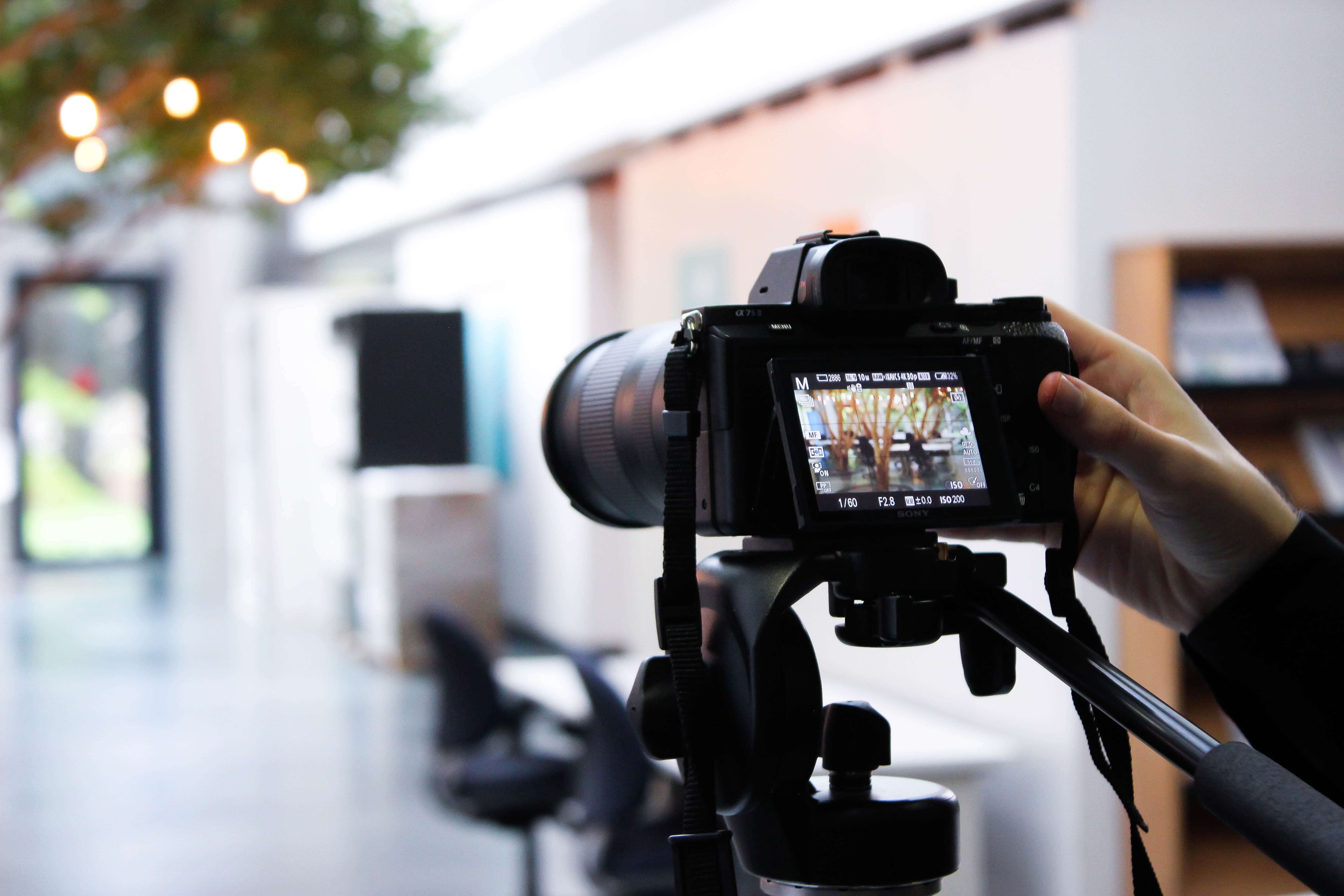 DSLR camera filming b-roll footage in a modern office environment